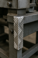 Aluminium chequer plate corner guard on metal frame.