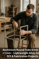 Man assembling a lightweight aluminum round tube frame for DIY fabrication projects