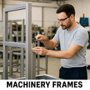 Worker assembling aluminium machinery frame with a hex key in an industrial workshop.