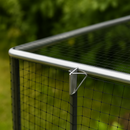 Fruit cage corner with spring clip securing aluminum frame.