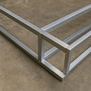 Aluminium frame structure on concrete floor.