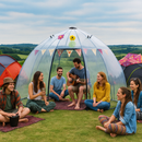 Group of friends enjoying music and conversation inside a clear dome tent outdoors.