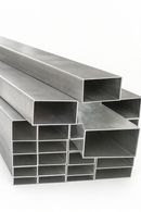 Pile of large and small aluminium rectangular tubes stacked neatly on a white background.