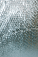 Reflective bubble insulation lining with raised circular texture.